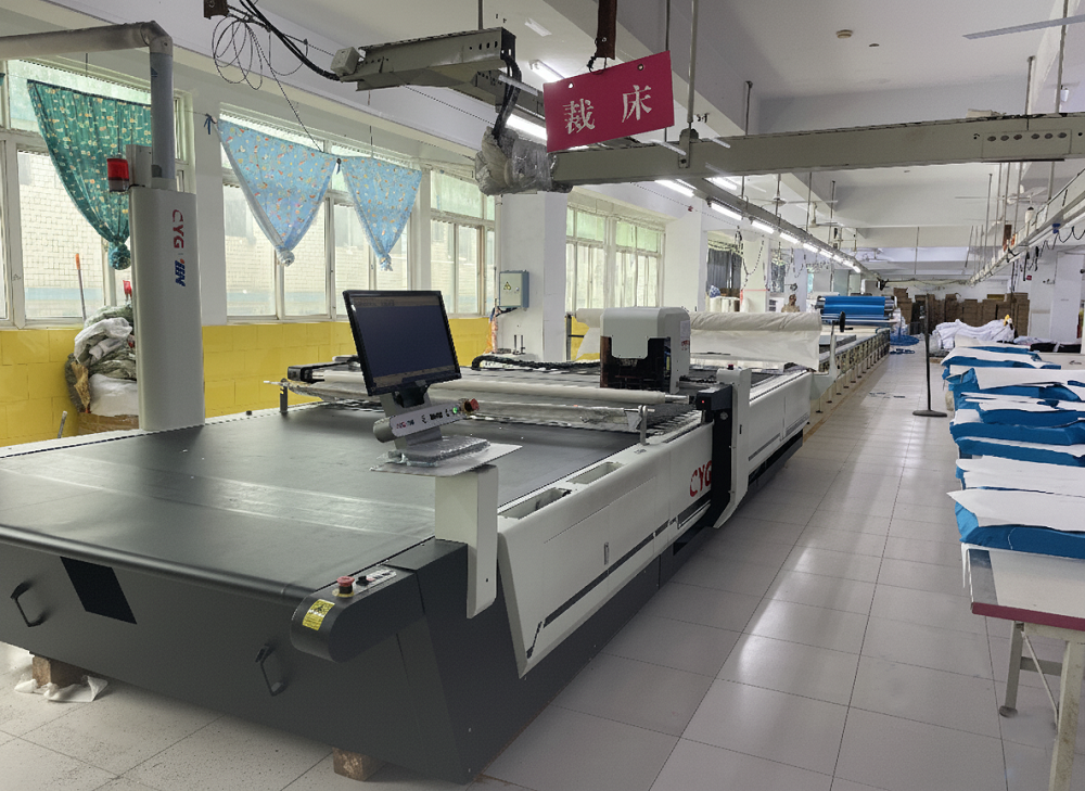 Automatic computer-controlled fabric cutting machine at Vista Clothing factory