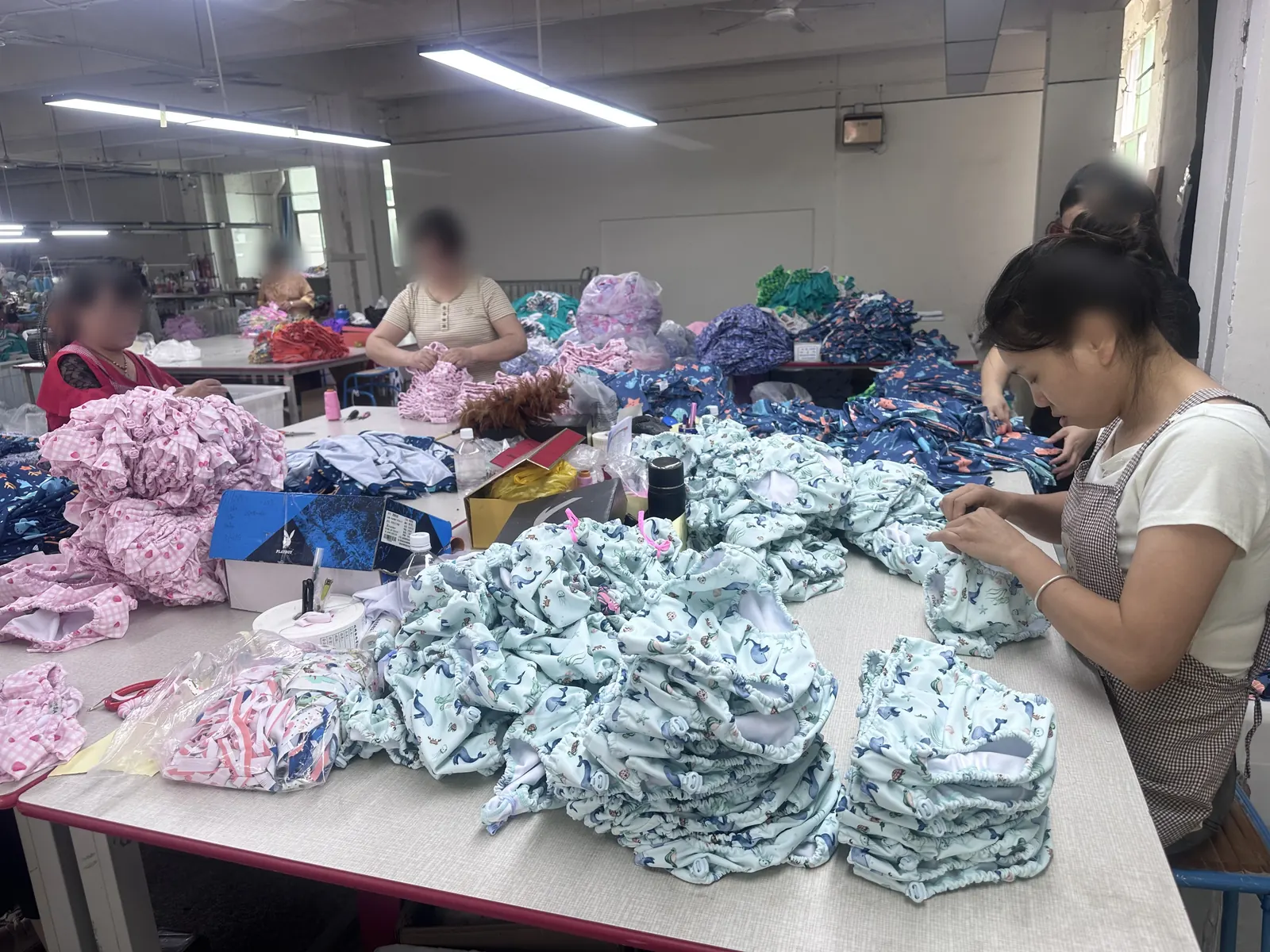 Workers inspecting garment quality at the Vista Clothing Quanzhou factory
