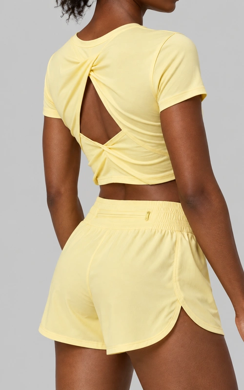 Women's twist-back crop top and running shorts set detail view