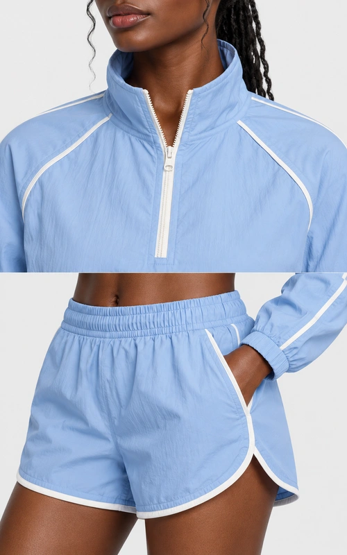 Women's powder blue half-zip track set detail view